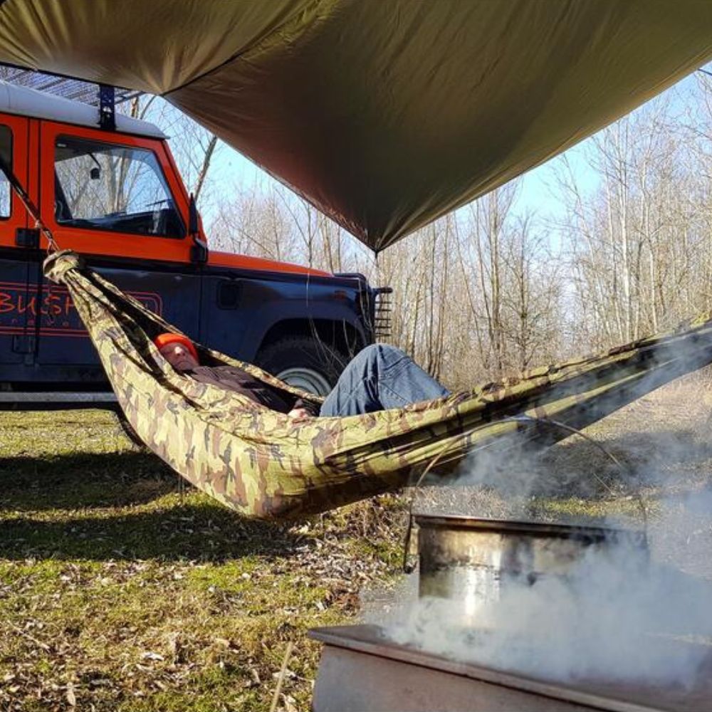 Bushmen 4×4m Thermo Tarp (Olive) person sleeping in hammock