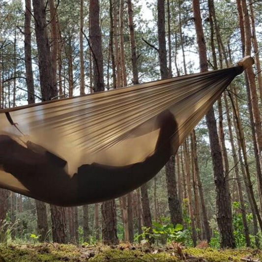 Bushmen Ultralight Hammock (Dark Olive) hanging in tree