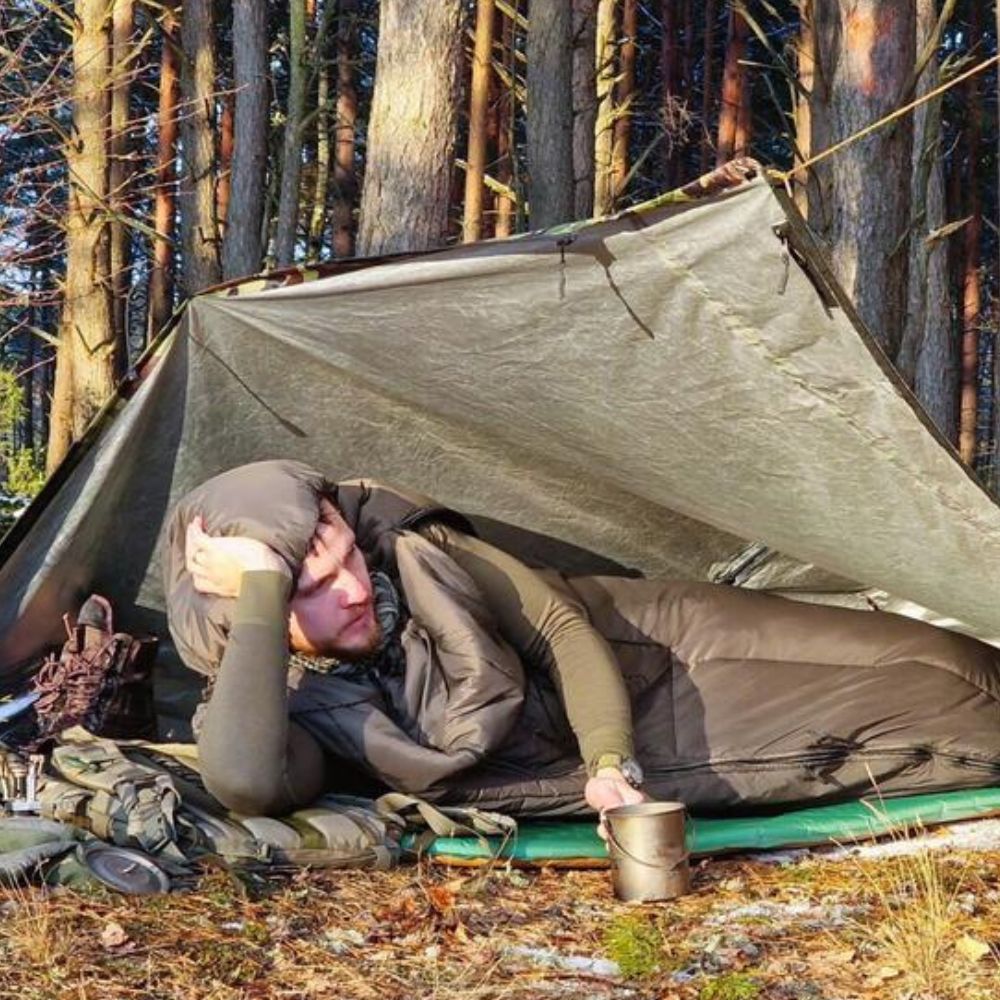 Bushmen Walker 1L Sleeping Bag (Olive) being used under tarp