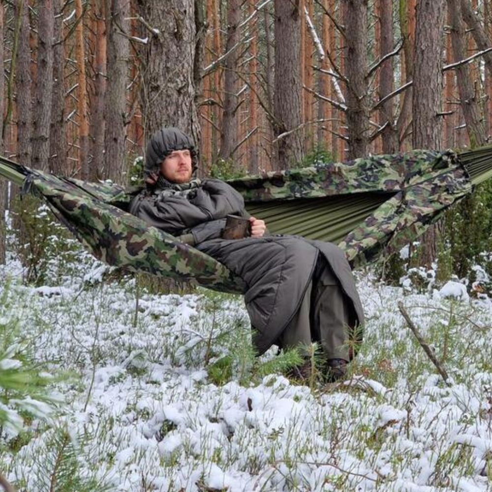 Bushmen Walker 1L Sleeping Bag (Olive) being used in snowy woods in hammock