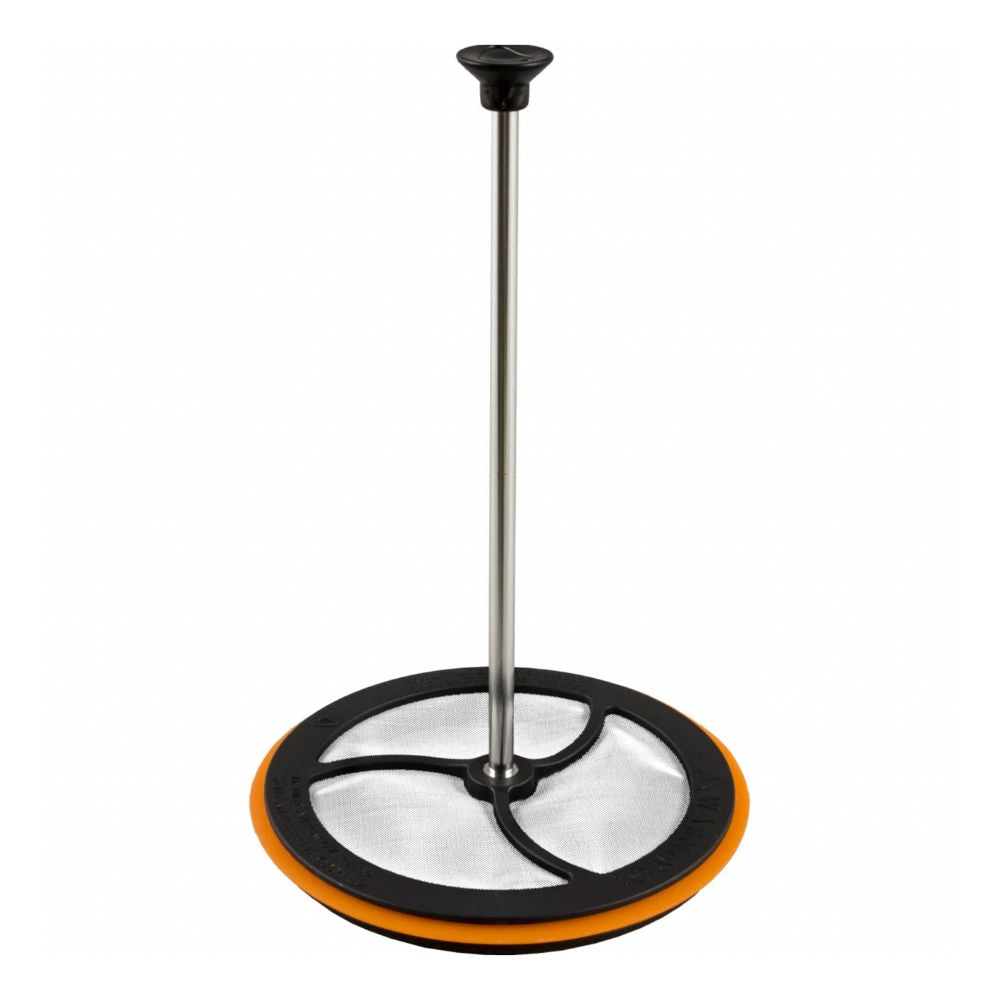 Cleaning tool with a round orange base and black handle on a white background