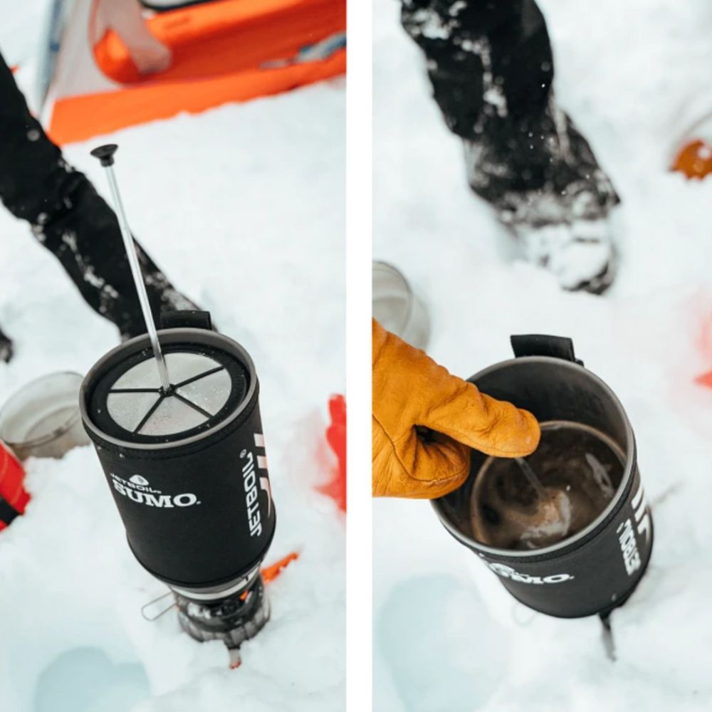 Nuumo camping stove and mug being used in a snowy outdoor setting