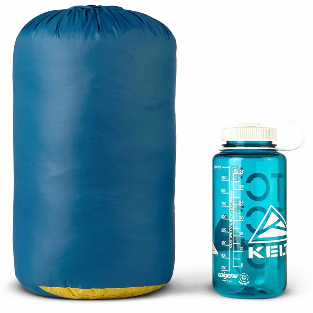 Blue compression sack and blue water bottle with white cap on a white background