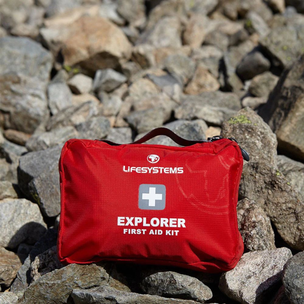 Red Lifesystems Explorer First Aid Kit on a rocky surface