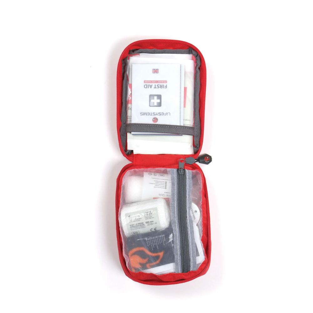 Red Lifesystems Trek First Aid Kit with visible contents on a white background
