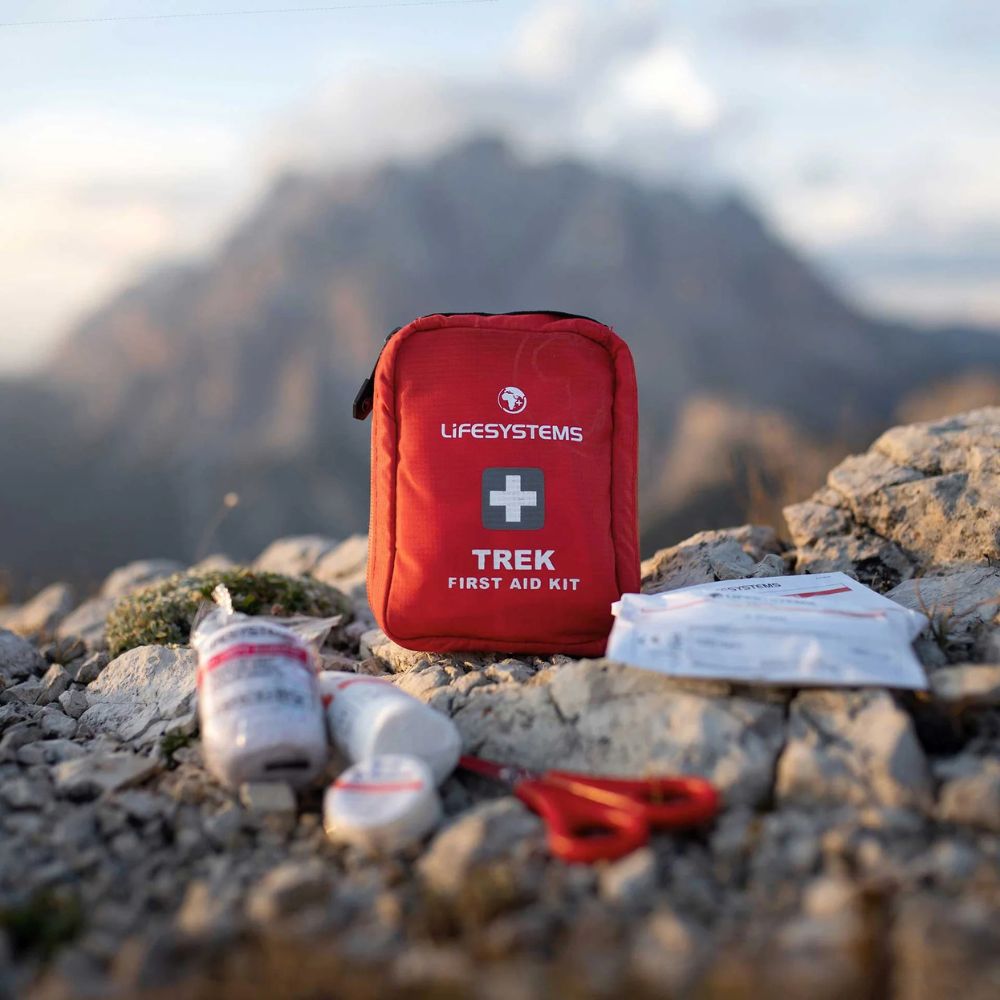 Red Lifesystems Trek first aid kit on a rocky mountain background