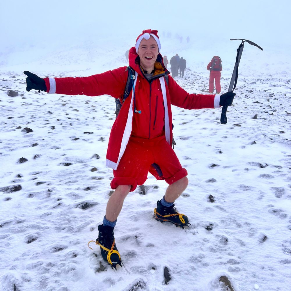 Matt_Hall_in_the_snow_santa_suit_at_the_top_of_ben_nevis_scotland_December_2023
