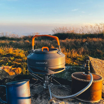 Camping stove with kettle and mug on a natural background