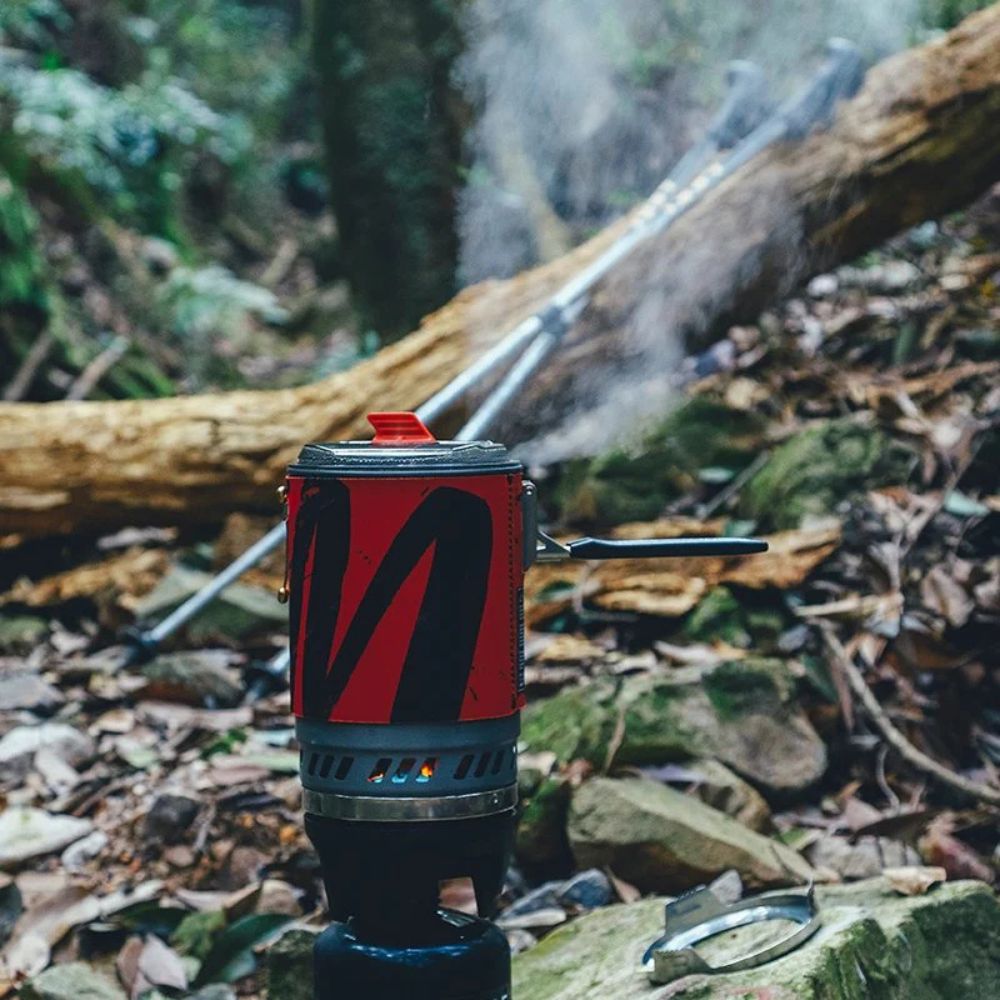 Red and black camping stove on a natural background