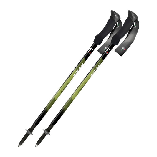 Two green and black hiking poles on a white background