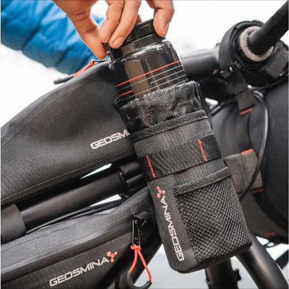 Bicycle water bottle holder with Geosmina branding attached to a bike.