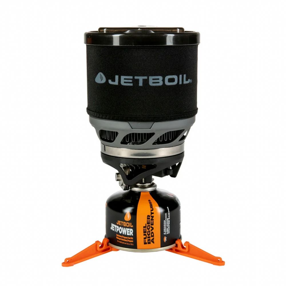 Jetboil stove with black lid and orange legs on a white background