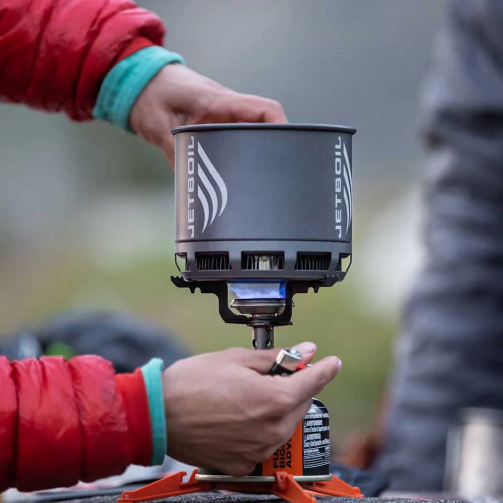 Person using a Jetboil stove outdoors
