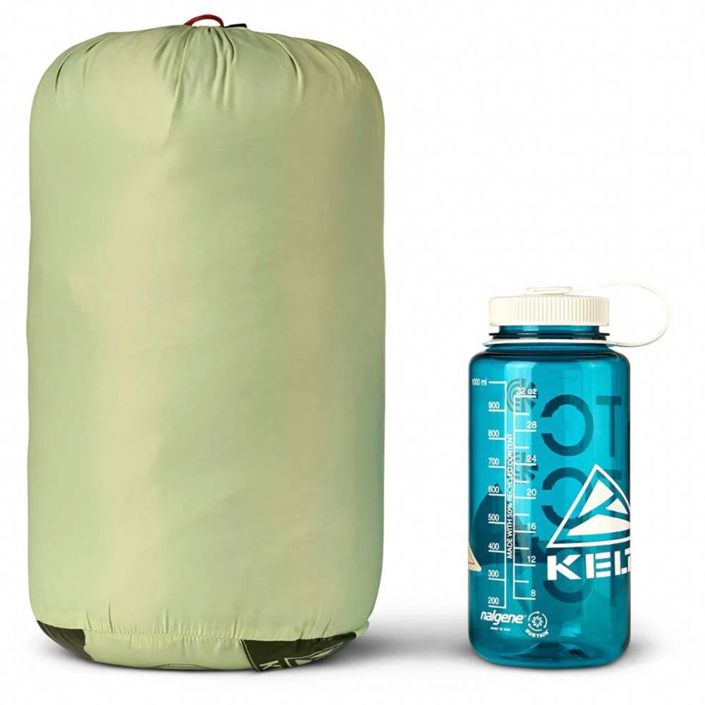 Green compression sack and blue Nalgene water bottle on a white background