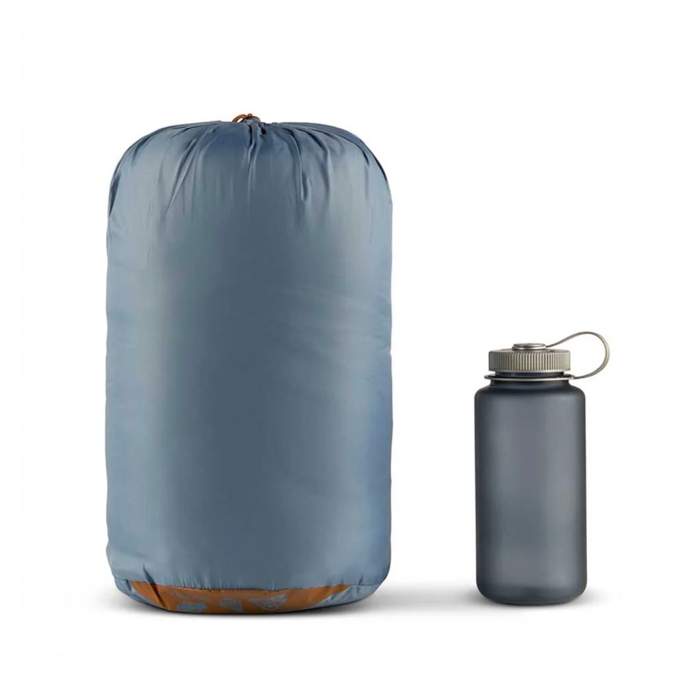Blue compression sack and gray water bottle on a white background