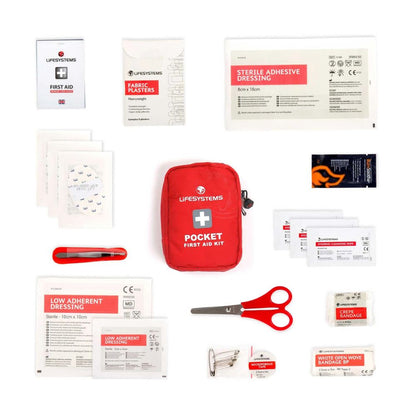 Collection of first aid items including a red Lifesystems pocket first aid kit on a white background.