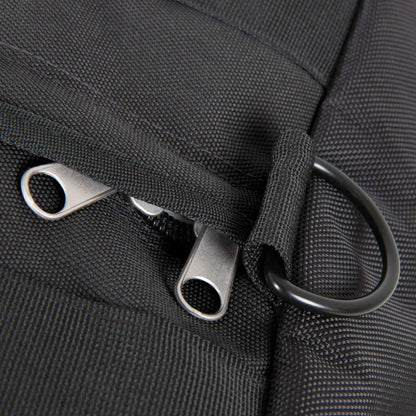 Close-up of a black bag with metal zippers and hooks.