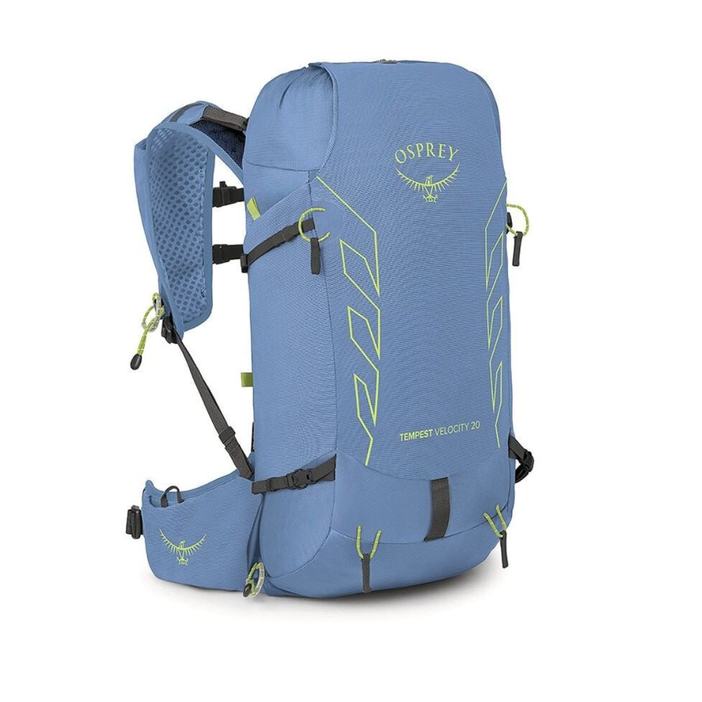 A blue Osprey Transfert Velocity 20 hiking backpack shown from a three-quarter angle on a white background, featuring lime green accents and black straps.
