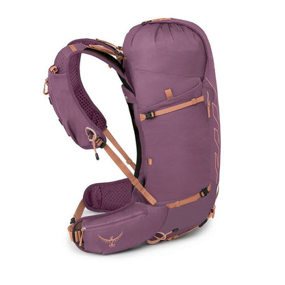 A purple Osprey backpack shown from a three-quarters angle against a plain white background, featuring tan straps and buckles.