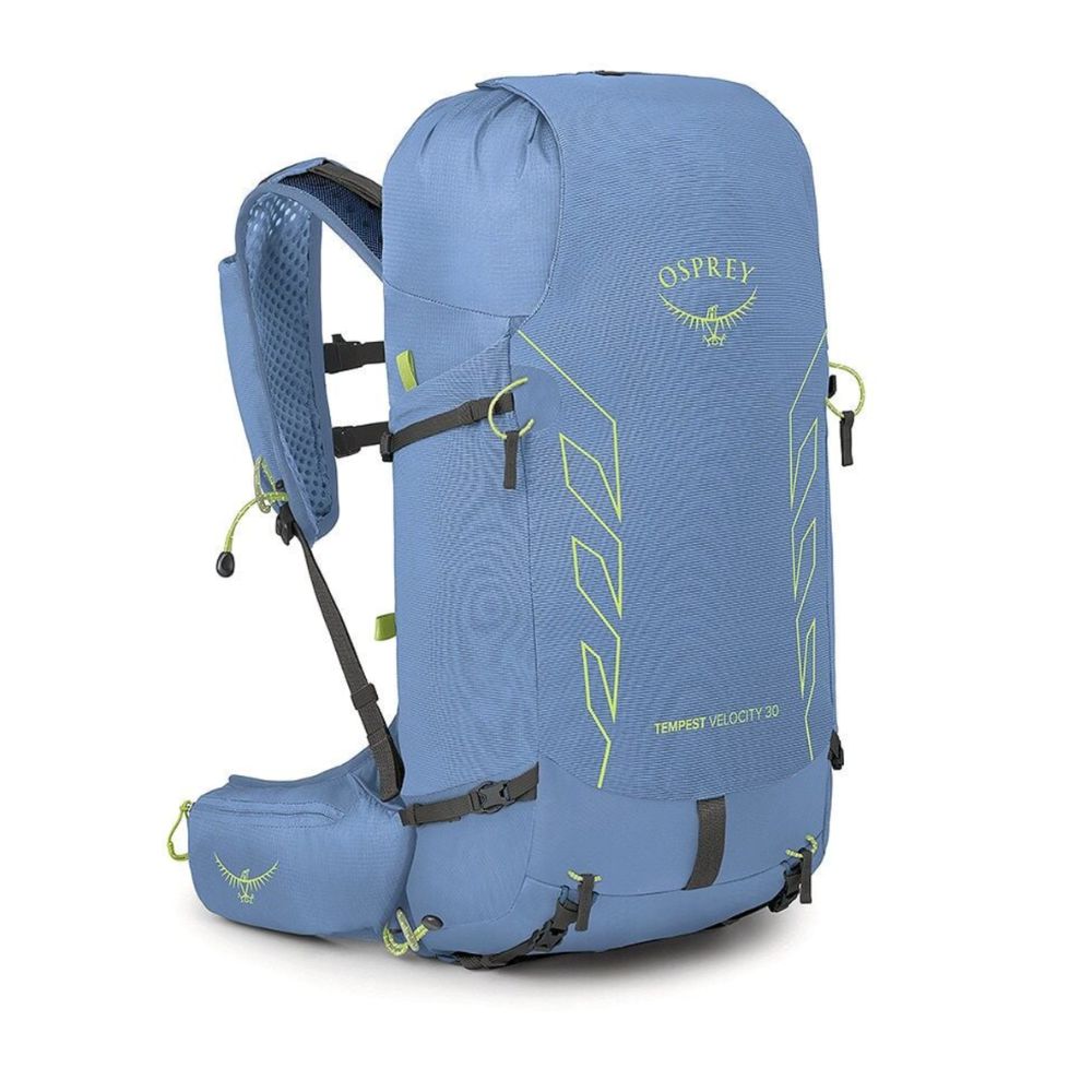 A blue Osprey Trippet Velocity 30 hiking backpack shown from a three-quarter angle against a white background, featuring lime green accents and the Osprey logo.